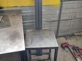 a picture of a table and two stools in a room