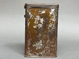 a small metal container with a rusted surface on it