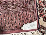 a close up of a rug with a tag on it