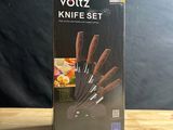 the box of a knife set is sitting on a wooden table