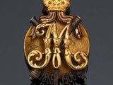 a close up of a gold badge with a crown on it