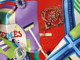 a close up of a colorful scarf with a broochet on it
