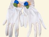 a pair of white gloves with blue flowers on them