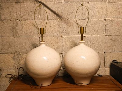 two lamps that are sitting on a wooden table