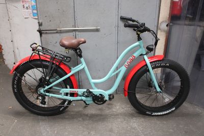 a blue and red bike parked in front of a building