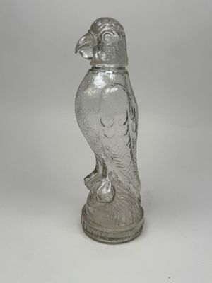 an image of a glass figurine of a bird on a pedestal