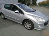 a picture of a silver car parked in front of a building