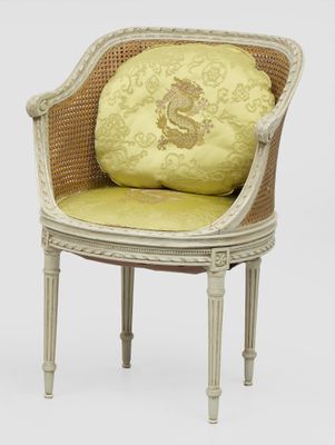an image of a white chair with a yellow cushion on top of it