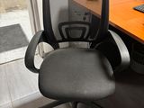 a desk with a computer and a chair in front of it