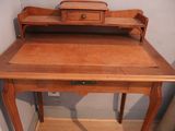 a wooden desk with a drawer on top of it
