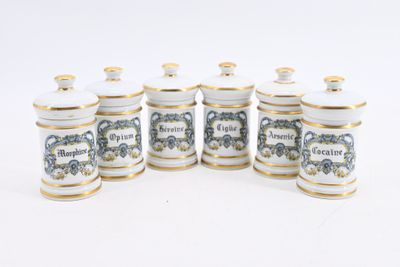 six white and gold canisters with blue and white designs on them