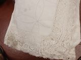 a white pillow on a brown chair with a white pillow on it