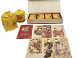 a box of cards and a teapot on the table