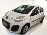 a picture of a small white car parked in a garage