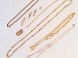 une collection de colliers et de bracelets en or posés sur un fond blanc