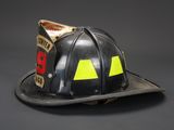 an old fireman ' s helmet with yellow and black markings