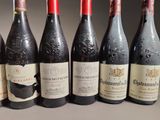 several bottles of wine are lined up on a table