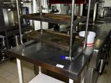 a kitchen with a lot of stainless steel counter tops