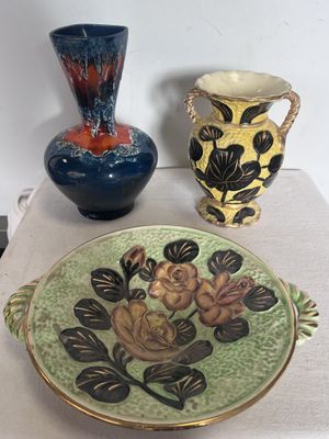 trois vases et une assiette posés sur une table