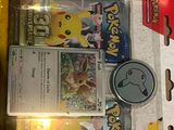 a box of pokemon cards and a watch inside of it