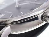 a close up of a watch with a black face