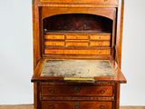 an old wooden desk with a marble top and drawers