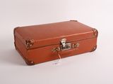 a small brown suitcase sitting on a white surface