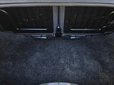 the trunk of a white car with the trunk lid open