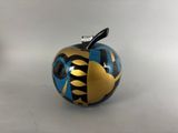 blue and gold apple ornament with black and gold design