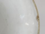 a white bowl that has a tag on the side of it