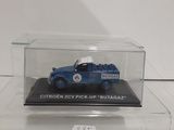 the blue truck is in a clear box on a white surface