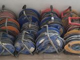 a lot of hoses that are stacked on a rack