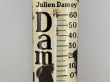 an old fashioned thermometer with a picture of a cat on it