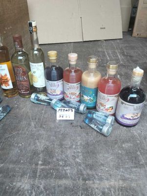many bottles of alcohol sitting on the floor next to each other