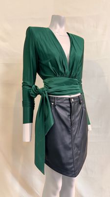 the dress is green and black with a belt on the waist