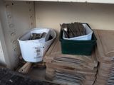 a stack of wood chips and a bucket of spoons on a shelf
