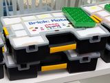 many boxes of legos sitting on a shelf in a room