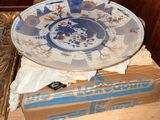 a blue and white plate sitting on top of a box