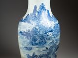 a blue and white vase with a mountain scene on it