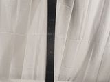 a snowboard leaning up against a white curtain