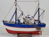a model of a boat on a stand on a white surface