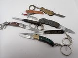 five different types of knives and a keychain on a table