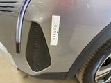 a close up of a car ' s front bumper with a sticker on it