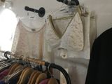 a rack of clothes hanging on a wall in a room