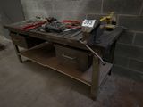 a workbench with tools on top of it in a room