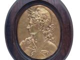 an image of a bronze medallion of a woman