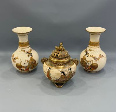 three white and gold vases with birds and flowers on them