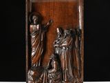 a bronze relief of jesus and mary on a wooden plaque
