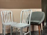 two chairs sitting next to each other on a tiled floor