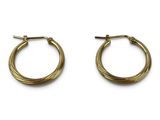 a pair of gold hoop earrings on a white background